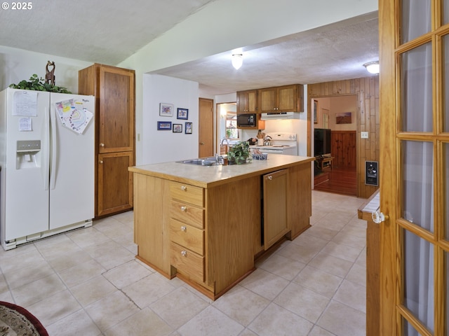 205 Baker Rd, Ariel, WA 98603 - kitchen with white appliances, a textured ceiling, light countertops, a kitchen island with sink, and light tile patterned flooring