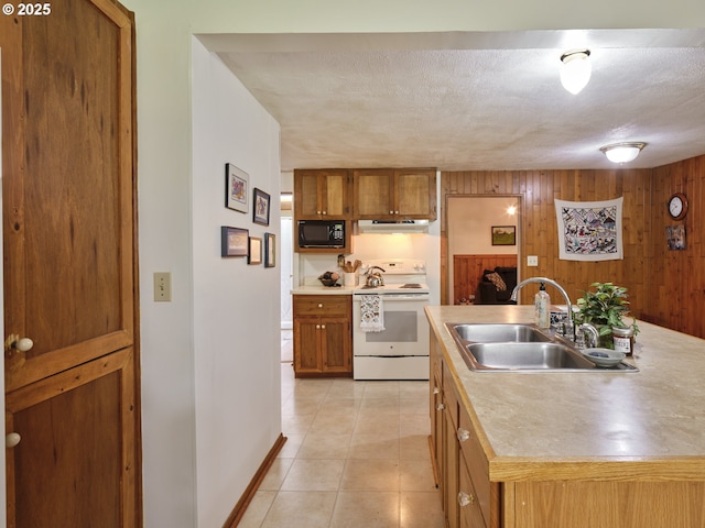 205 Baker Rd, Ariel, WA 98603 - kitchen featuring white range with electric stovetop, black microwave, under cabinet range hood, brown cabinets, and wooden walls