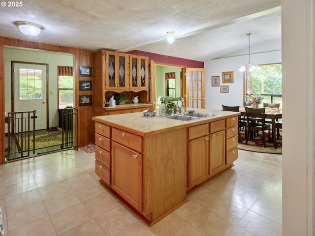 205 Baker Rd, Ariel, WA 98603 - kitchen featuring plenty of natural light, light countertops, a center island with sink, a textured ceiling, and vaulted ceiling