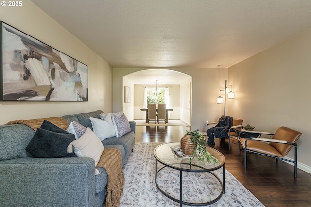 2614 NE 176th Ave, Vancouver, WA 98684 - living room with arched walkways, wood finished floors, a chandelier, and baseboards