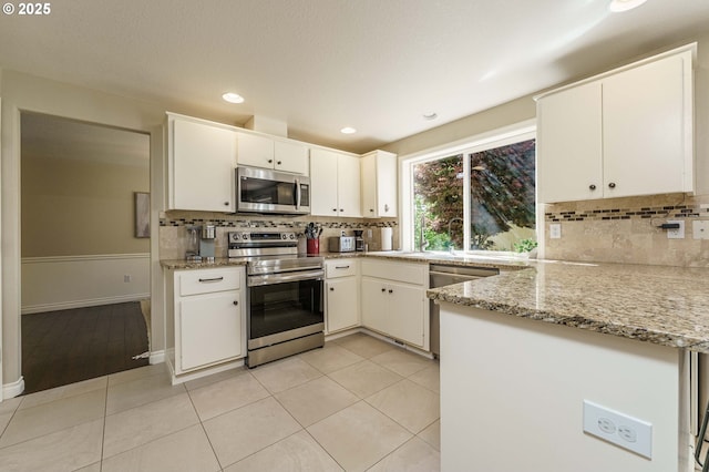 2614 NE 176th Ave, Vancouver, WA 98684 - kitchen with stainless steel appliances, tasteful backsplash, white cabinetry, and recessed lighting