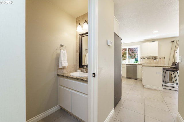 2614 NE 176th Ave, Vancouver, WA 98684 - bathroom featuring backsplash, tile patterned flooring, vanity, and baseboards