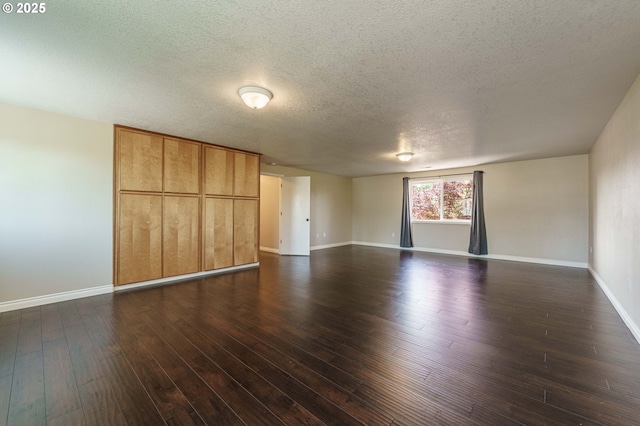 2614 NE 176th Ave, Vancouver, WA 98684 - unfurnished living room with a textured ceiling, baseboards, and dark wood finished floors