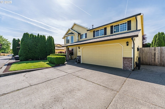 2614 NE 176th Ave, Vancouver, WA 98684 - traditional-style home featuring fence, an attached garage, brick siding, and driveway