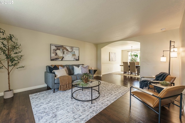 2614 NE 176th Ave, Vancouver, WA 98684 - living area featuring arched walkways, dark wood-type flooring, and baseboards