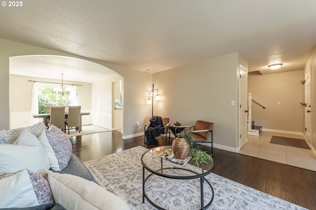 2614 NE 176th Ave, Vancouver, WA 98684 - living room featuring arched walkways, hardwood / wood-style floors, stairway, and a textured ceiling