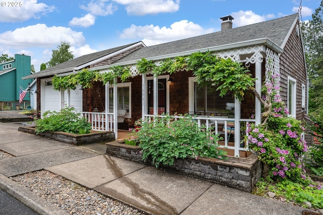 10001 SW 35th Ave, Portland, OR 97219 - view of front of house featuring a porch, roof with shingles, and a chimney