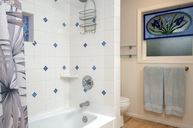 10001 SW 35th Ave, Portland, OR 97219 - bathroom with shower / tub combo with curtain, wainscoting, and wood finished floors