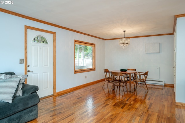 10001 SW 35th Ave, Portland, OR 97219 - dining space with hardwood / wood-style floors, a chandelier, crown molding, and a baseboard heating unit