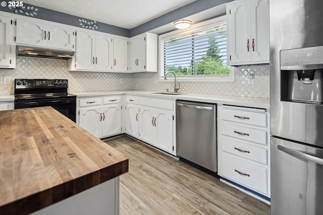 3780 SE 21st Dr, Gresham, OR 97080 - kitchen with stainless steel appliances, under cabinet range hood, butcher block countertops, a sink, and light wood-style floors