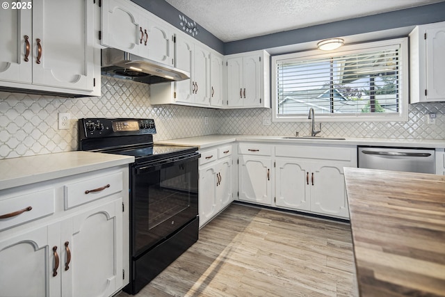 3780 SE 21st Dr, Gresham, OR 97080 - kitchen with under cabinet range hood, black range with electric stovetop, a sink, stainless steel dishwasher, and white cabinets