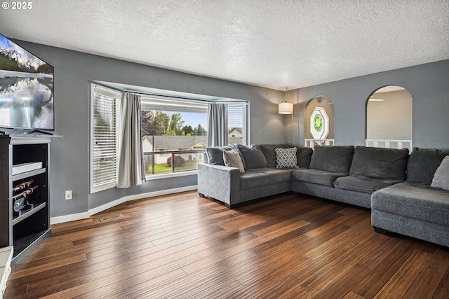 3780 SE 21st Dr, Gresham, OR 97080 - living area featuring a textured ceiling, arched walkways, wood finished floors, and baseboards