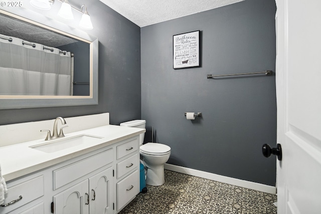 3780 SE 21st Dr, Gresham, OR 97080 - full bath featuring a textured ceiling, vanity, toilet, baseboards, and tile patterned floors