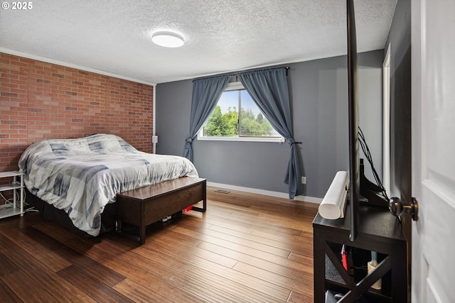 3780 SE 21st Dr, Gresham, OR 97080 - bedroom featuring a textured ceiling, baseboards, brick wall, and hardwood / wood-style floors