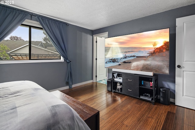 3780 SE 21st Dr, Gresham, OR 97080 - bedroom with dark wood-style flooring, a textured ceiling, and baseboards