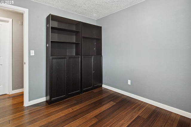 3780 SE 21st Dr, Gresham, OR 97080 - unfurnished bedroom with baseboards, a closet, dark wood-type flooring, and a textured ceiling