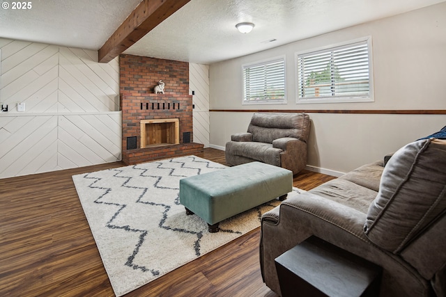 3780 SE 21st Dr, Gresham, OR 97080 - living area with a textured ceiling, wood finished floors, baseboards, beamed ceiling, and a brick fireplace