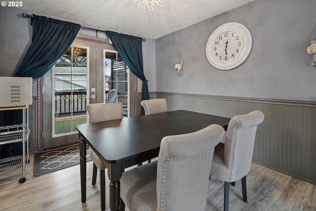 3780 SE 21st Dr, Gresham, OR 97080 - dining room with wood finished floors, wainscoting, and a textured ceiling
