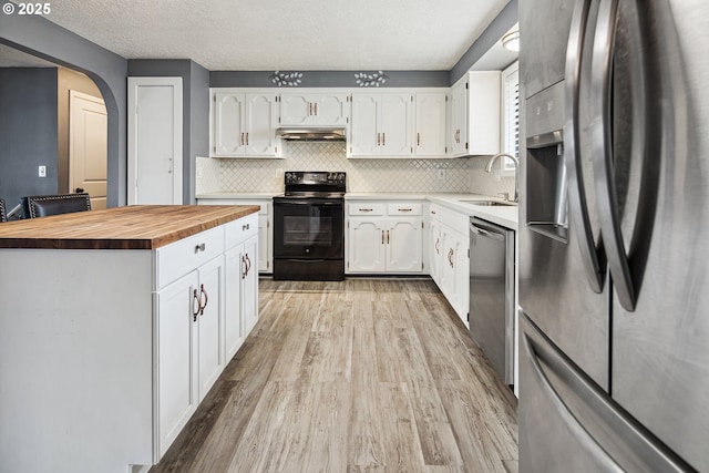 3780 SE 21st Dr, Gresham, OR 97080 - kitchen featuring appliances with stainless steel finishes, wooden counters, a sink, under cabinet range hood, and light wood-style flooring