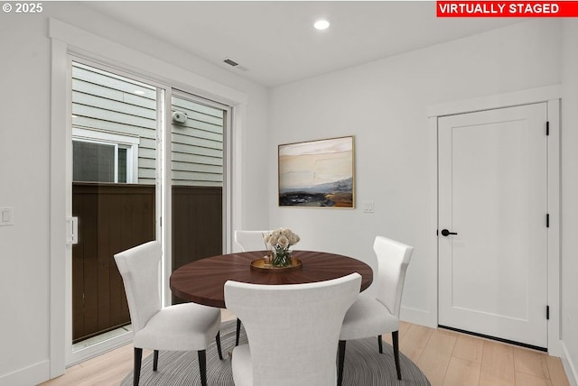 dining area with light hardwood / wood-style floors