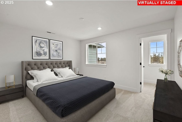 carpeted bedroom featuring multiple windows