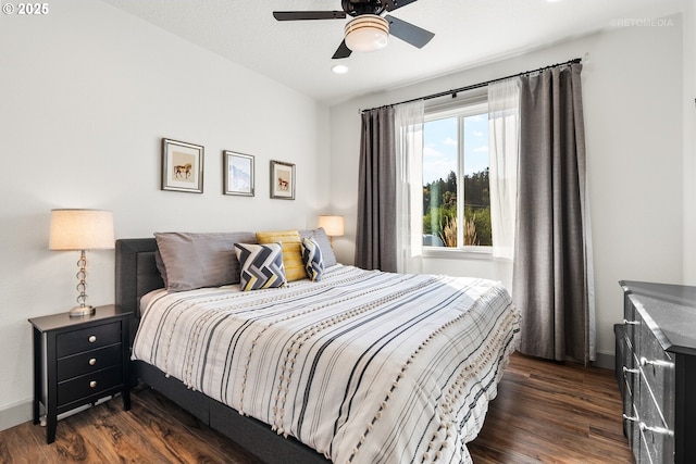 bedroom featuring a ceiling fan, dark wood-style flooring, and baseboards