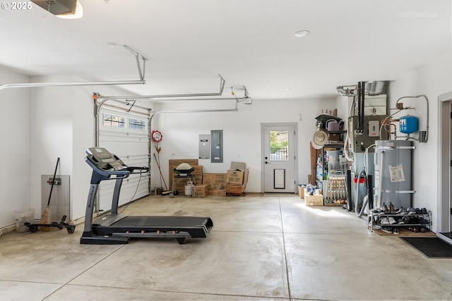 interior space with a garage, secured water heater, and electric panel