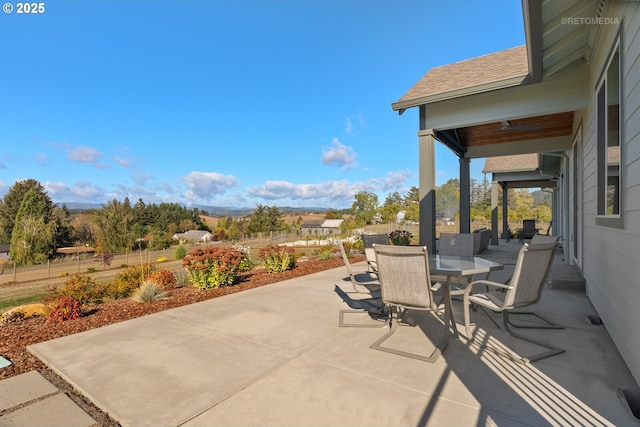 view of patio featuring outdoor dining space and fence