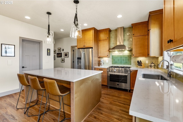 kitchen with a sink, backsplash, a center island, wall chimney exhaust hood, and high end appliances