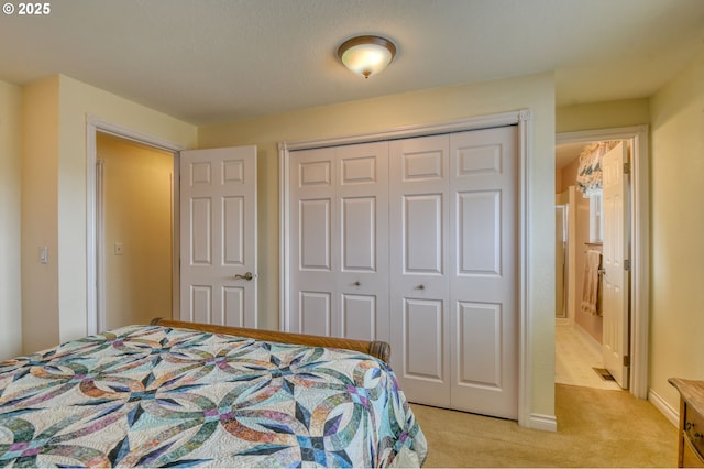 bedroom featuring light colored carpet and a closet