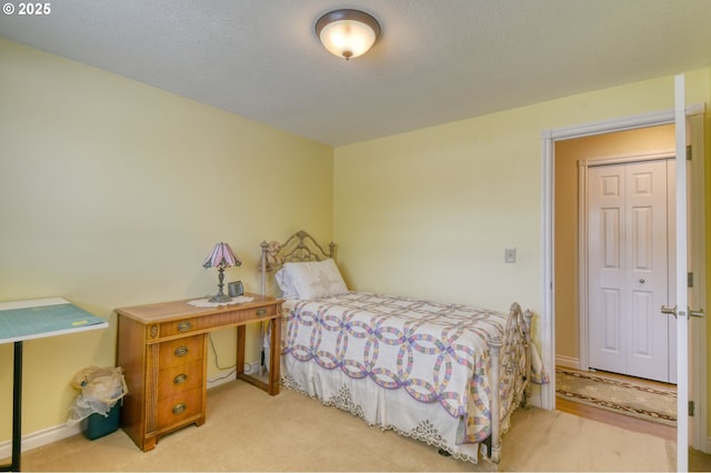 bedroom with baseboards and light carpet