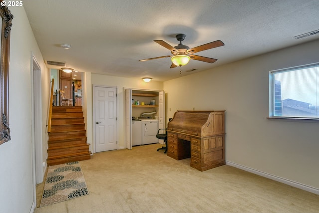 office area featuring ceiling fan, light carpet, visible vents, and washer and dryer