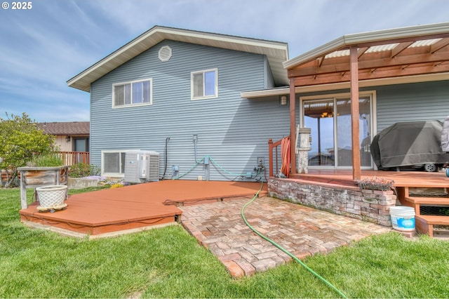back of property featuring a yard, a patio area, and a deck