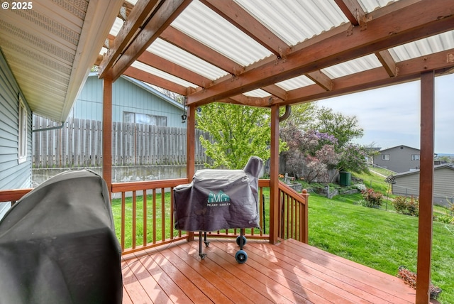 deck with a lawn, fence, and area for grilling