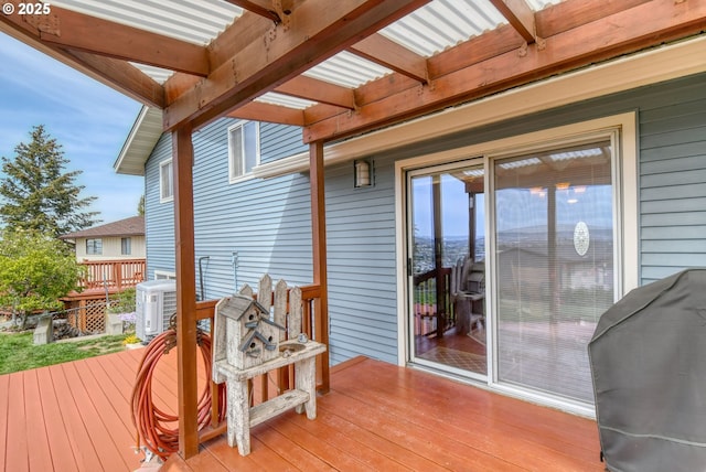 wooden terrace featuring cooling unit and a grill