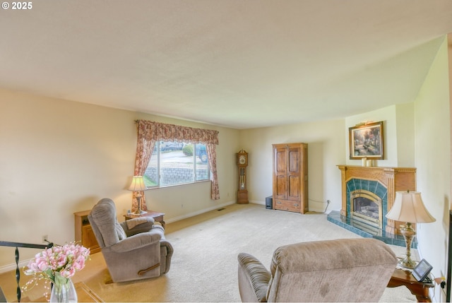 carpeted living area featuring a tiled fireplace and baseboards