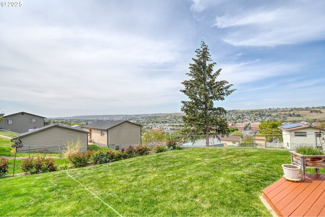 view of yard with a residential view, fence, and a deck