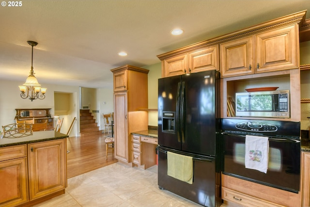 kitchen with hanging light fixtures, black appliances, a notable chandelier, dark stone counters, and recessed lighting