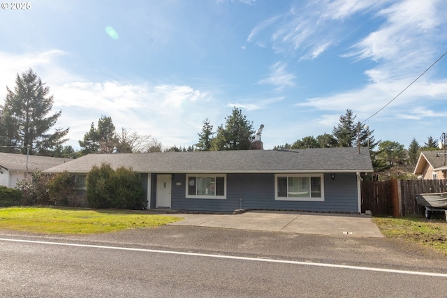 ranch-style home with a chimney, fence, and a front yard