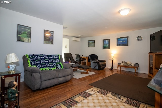 living room with a wall mounted AC and wood finished floors