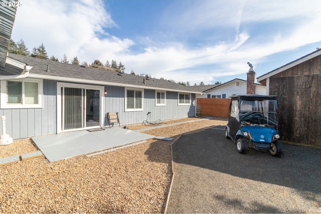 rear view of property with a patio area and fence