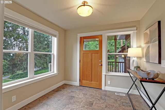 10455 NW Laidlaw Rd, Portland, OR 97229 - entrance foyer with healthy amount of natural light and light stone finish floors