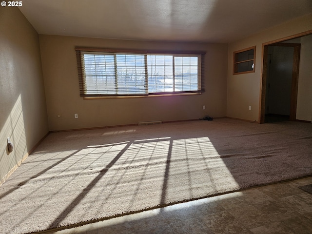 unfurnished room with light carpet