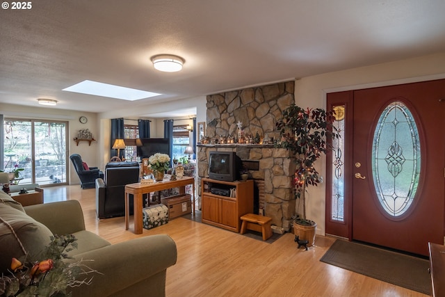 foyer entrance featuring hardwood / wood-style flooring and a skylight