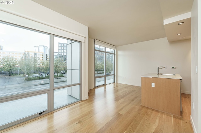1260 NW Naito Pkwy Unit 200B, Portland, OR 97209 - living room featuring floor to ceiling windows, light wood-type flooring, and recessed lighting