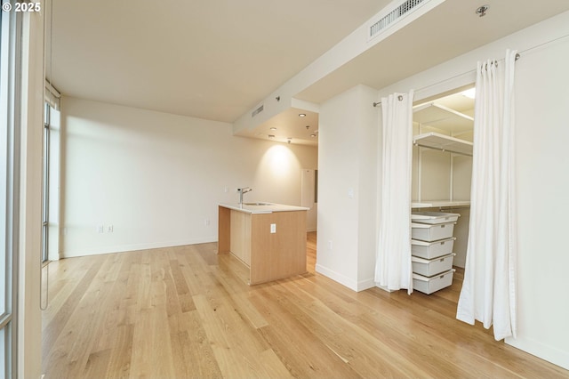 1260 NW Naito Pkwy Unit 200B, Portland, OR 97209 - bedroom with light wood-style flooring, baseboards, stainless steel fridge with ice dispenser, and a sink