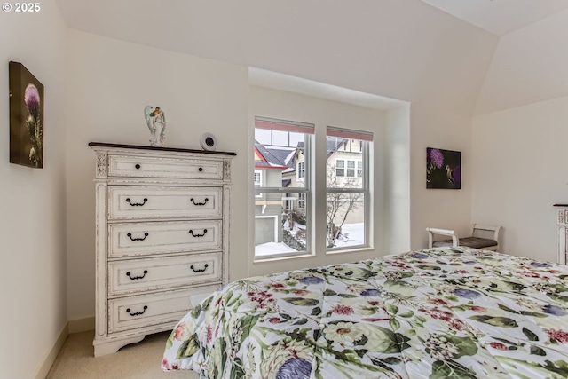 carpeted bedroom featuring lofted ceiling