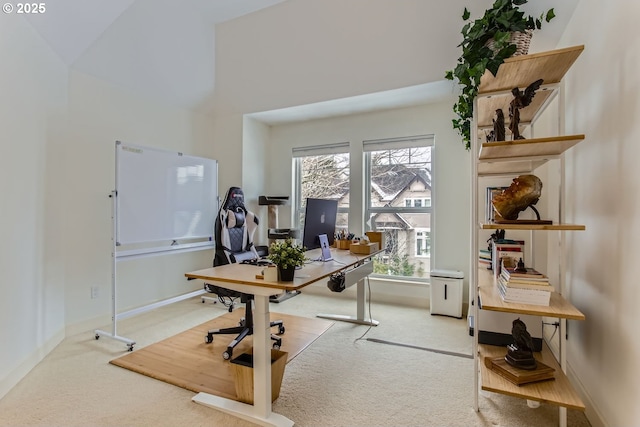 office featuring carpet floors and a towering ceiling