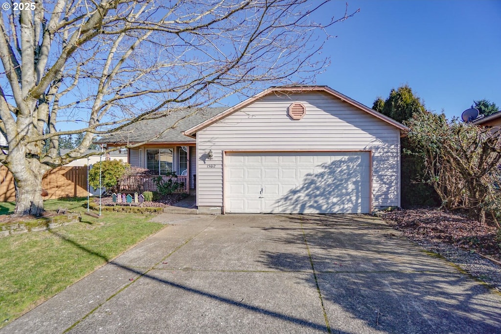 view of front of property featuring a garage and a front yard