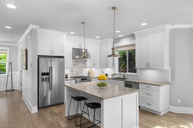2516 N Watts St, Portland, OR 97217 - kitchen featuring stainless steel appliances, wood finished floors, white cabinets, recessed lighting, and a center island